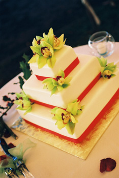 Rolled fondanr wedding cake with red ribbon
